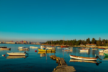 Old harbor with fishing boats in Tuzla. Blue sky and natural white clouds on day time. Small boats waiting for sail