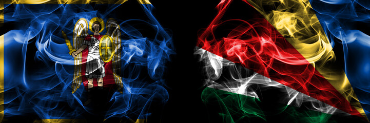 Kyiv, Kiev vs Seychelles, Seychellois flag. Smoke flags placed side by side isolated on black background.
