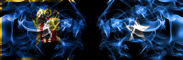 Kyiv, Kiev vs Somalia, Somali flag. Smoke flags placed side by side isolated on black background.