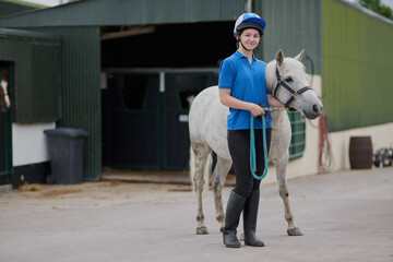 Forget glass slippers, this princess wears boots. Shot of a young girl and her horse outdoors.