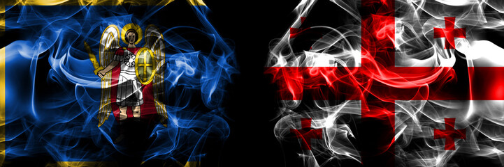 Kyiv, Kiev vs United States of America, America, US, USA, American, Georgia flag. Smoke flags placed side by side isolated on black background.