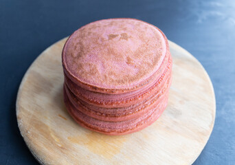 pila de cuatro hot cakes esponjosos sabor fresa integral sobre base de madera circular 