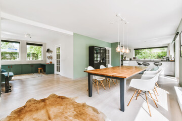 The interior of a beautiful dining room with large windows and parquet floors