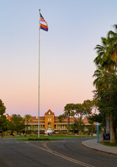 American and Arizona flags over Old Main on the campus of the University of Arizona at sunset