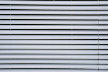 white large blinds with horizontal lines form an interesting pattern