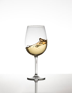 A glass of white wine on the move
