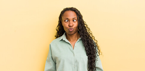 black pretty woman looking goofy and funny with a silly cross-eyed expression, joking and fooling...