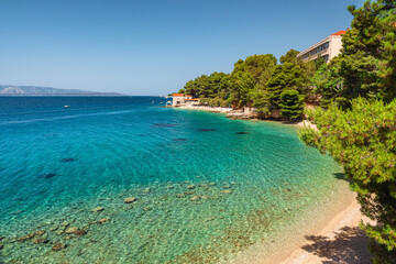 Croatia, Brac island, Bol. Beautiful view of pebble beach on Adriatic sea with small restaurant