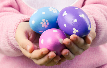 Easter eggs in child hands. Happy Easter holiday. Spring background.