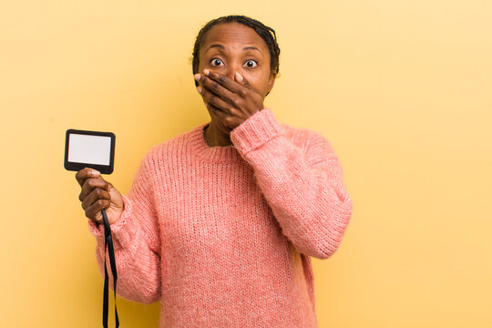 black pretty woman covering mouth with hands with a shocked