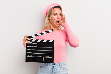 blonde pretty woman feeling happy, excited and surprised