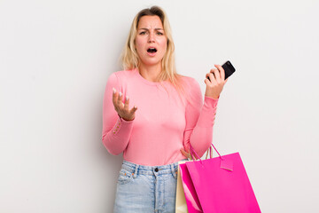 blonde pretty woman looking desperate, frustrated and stressed