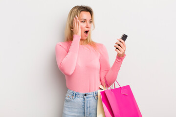 blonde pretty woman feeling happy, excited and surprised