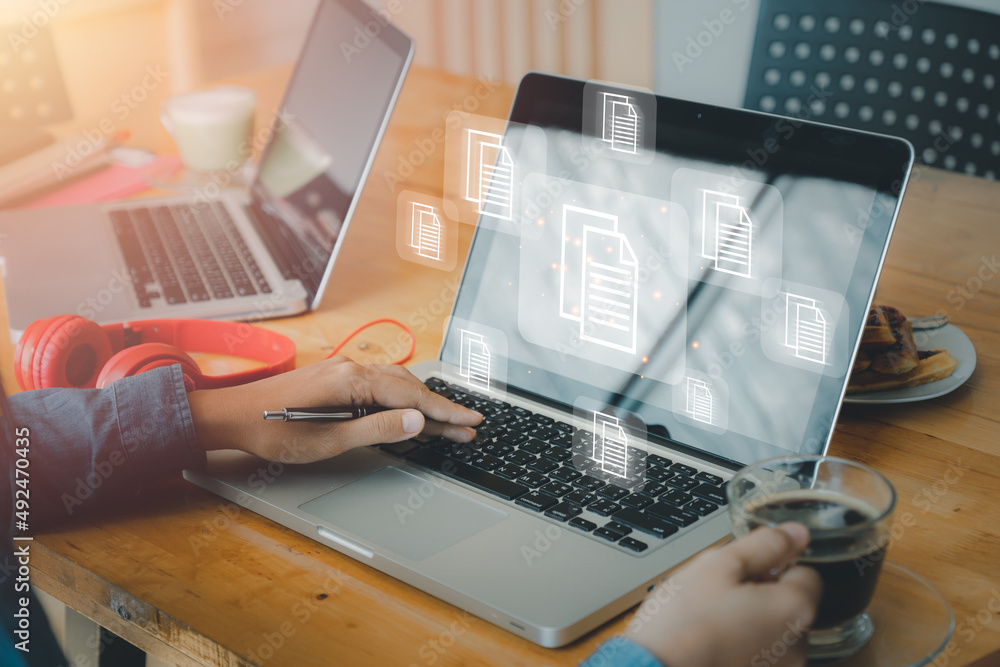 Poster business person hand using laptop computer with document management icon, document management data s