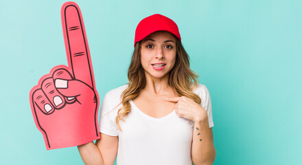 pretty woman feeling happy and pointing to self with an excited