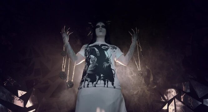 the sorceress stands in the smoke. voodoo rite