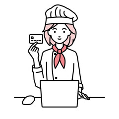 デスクで座ってPCを使いながらクレジットカードを手に持っている調理師の女性
