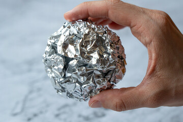 Wrinkled ball of aluminium foil. Recycling concept.