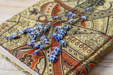 Dried lavender flowers over beautiful diary.
