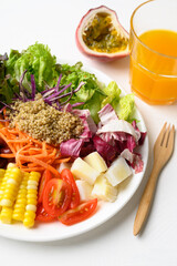 Mixed fresh salad organic vegetables with quinoa seeds and juice on white background, Healthy vegan food