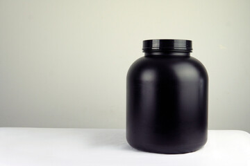 bodybuilding, healthy lifestyle concept. Whey protein powder on a wooden table and white background