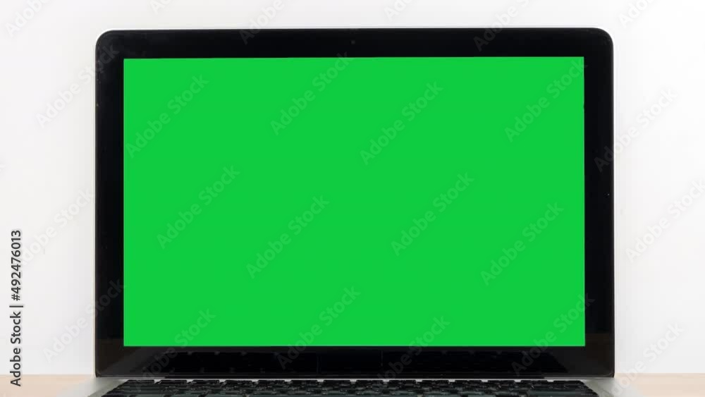 Aufkleber stop motion animation green screen laptop computer turning on wooden desk and zoom in display green 