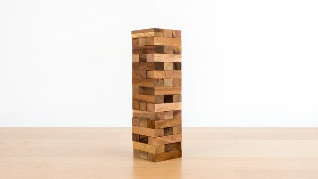 Stop motion animation Game with wooden blocks on white background, Wooden blocks stacked, Planning, risk and strategy in business.