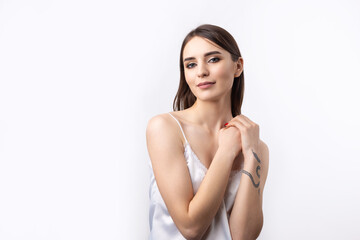 Obraz premium Beautiful smiling woman with clean skin, natural make-up and white teeth on a gray background