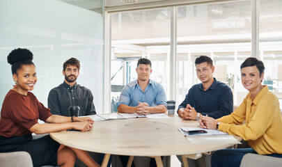 Were here to prove the excellence of our company. Portrait of a group of businesspeople having a meeting in an office.