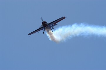 Fototapeta na wymiar Aerobatic airplane against the background of blue sky