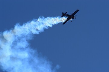 Fototapeta na wymiar Aerobatic airplane against the background of blue sky