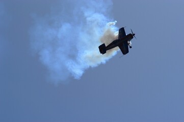 Aerobatic airplane against the background of blue sky