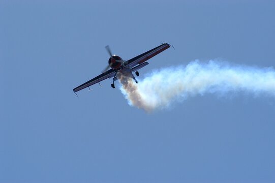 Aerobatic airplane against the background of blue sky