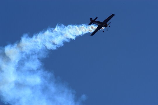 Aerobatic airplane against the background of blue sky