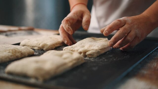 Man kneading dough with his hands to make bread