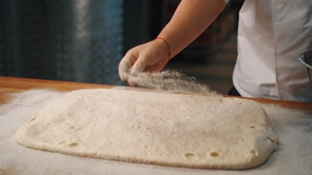 Man kneading dough with his hands to make bread