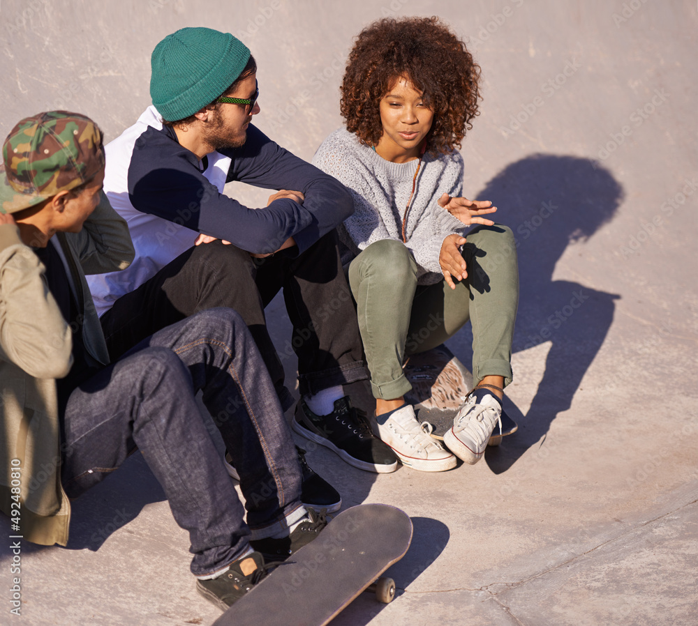 Poster going over technique. shot of a group of friends hanging out at a skate park.