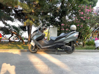 a small motorcycle scooter parked in the city street