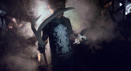 scary sorcerer in smoke. voodoo rite