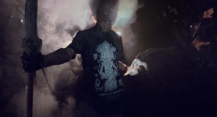scary sorcerer in smoke. voodoo rite