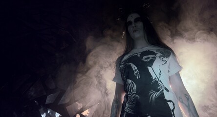 the sorceress stands in the smoke. voodoo rite