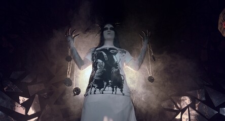 the sorceress stands in the smoke. voodoo rite