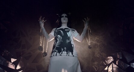 the sorceress stands in the smoke. voodoo rite