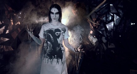 sorcerers stands in smoke. voodoo rite