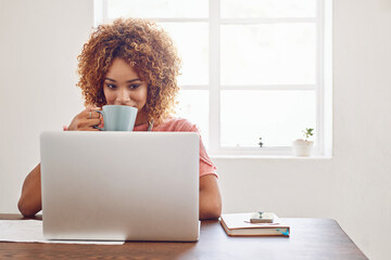 We never fail to be inspired and motivated by technology. Shot of a designer having coffee while...