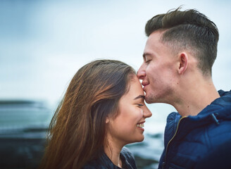 Fototapeta premium Young love sure is a beautiful thing. Shot of a happy young couple spending a romantic day together outdoors.