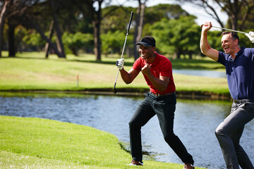 That one in a million shot. Shot of two golfers celebrating a great shot. - obrazy, fototapety, plakaty