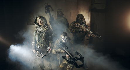 Fototapeta premium apocalypse fighters. a girl with a bow and a guy with crossbows.