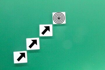white squares with arrow icons pointing to the target or the concept of the path to success