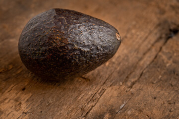 Ripe avocado isolated on wooden background 